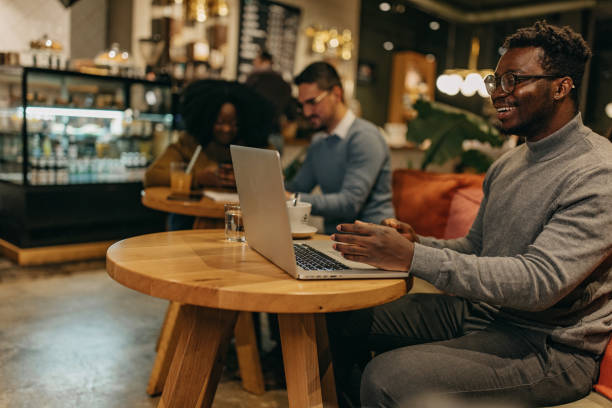 istock Photo of a man working from a cafeteria. 1442196029