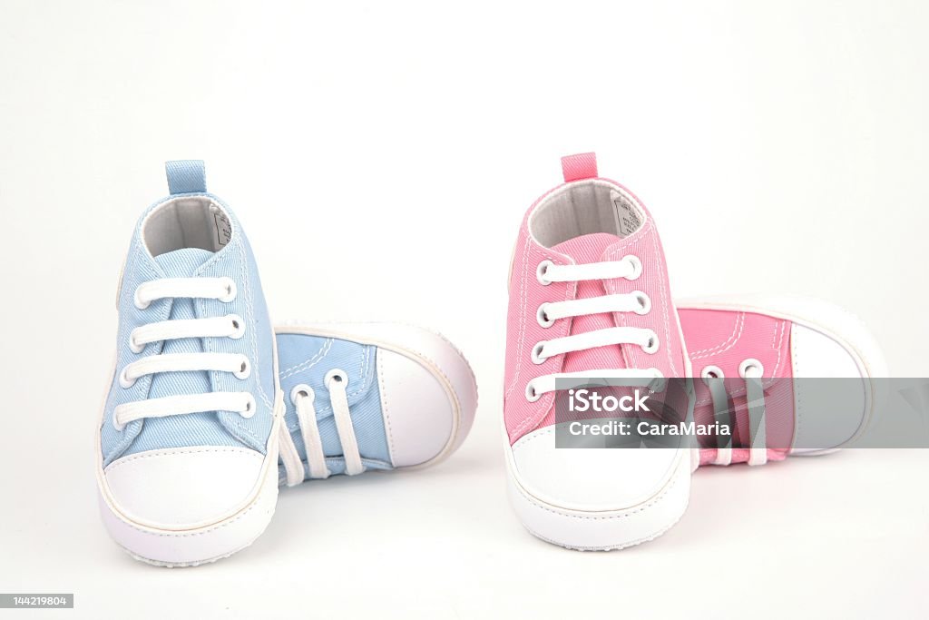 Two pairs of baby shoes, one pair blue and one pair pink blue and pink baby shoes-twins Shoe Stock Photo
