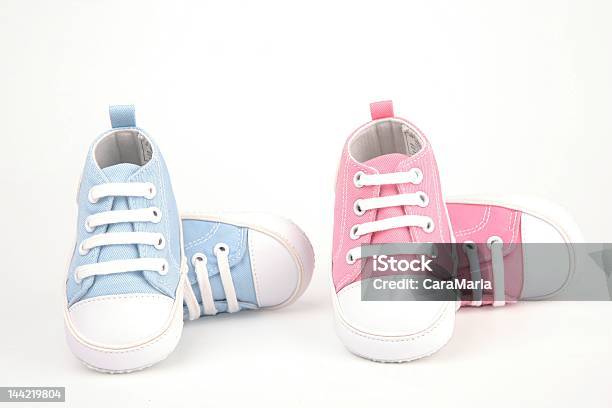 Two Pairs Of Baby Shoes One Pair Blue And One Pair Pink Stock Photo - Download Image Now