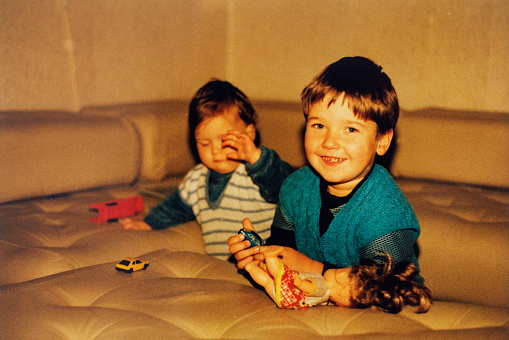 Vintage photo of brother and sister playing at home