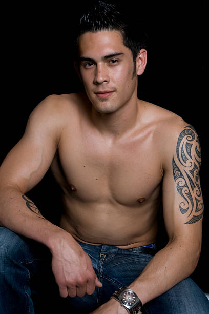 Young man with tatoo Young man with tatoos and a nacked torso shoulder tribal tattoos for men stock pictures, royalty-free photos & images