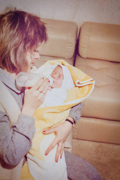 Mother feeding baby at eighties