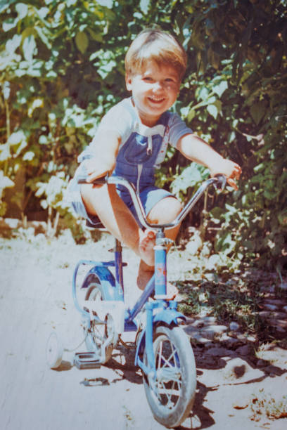 istock Smiling boy rides bicycle at eighties 1442205417
