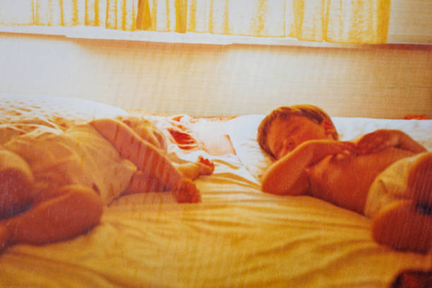 Brother and sister sleeping in camper at eighties