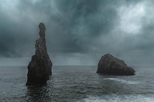 Islets of Ribeira da Janela in Porto Moniz, Madeira island, Portugal. Two large rock formations in the ocean near the coast.