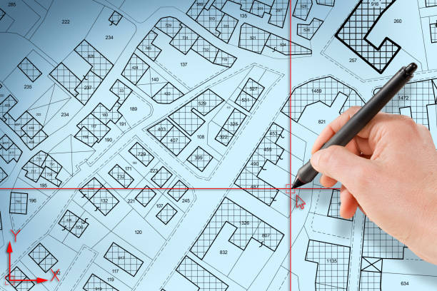 istock Imaginary cadastral map of territory with buildings and land plots drawn with a CAD (Computer-Aided-Design) computer software in dwg format file - concept with hand and digital pen 1442207107