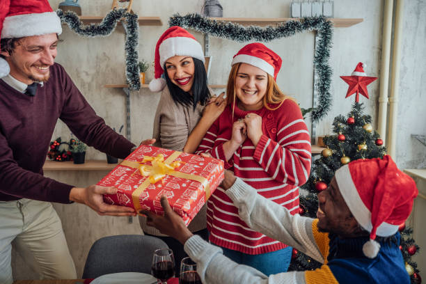 istock Friends exchanging gifts for New Year 1442208284