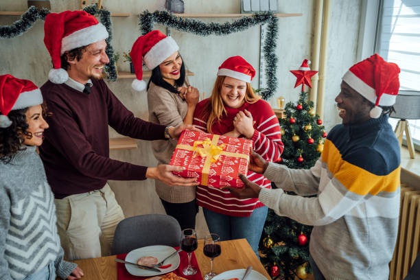 istock Friends exchanging gifts on New Year 1442208474