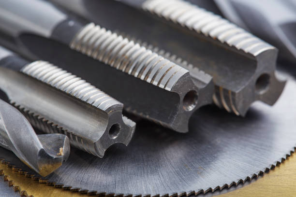 istock set of different drill bits,thread tap and mill cutters with caliper ruler on steel plate background. Locksmithing deal. 1442208857