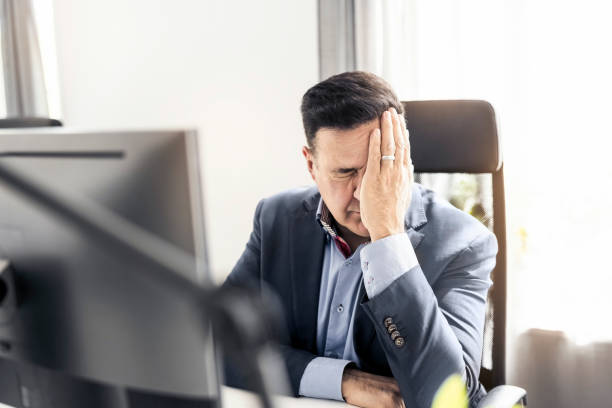 istock Upset businessman sitting at his desk in office 1442210014