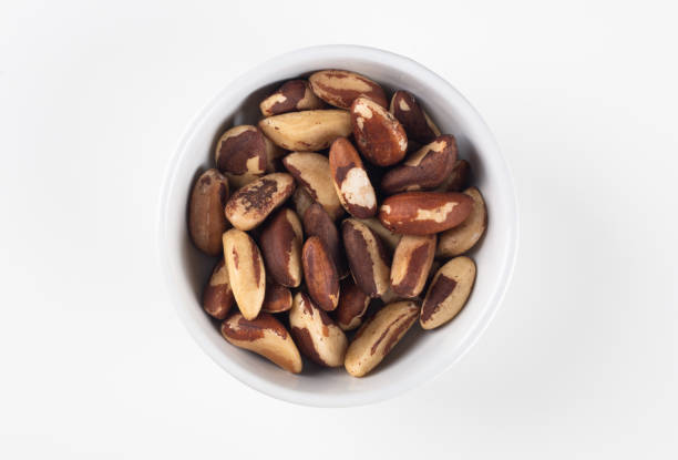 istock Bowl with Brazil nuts and white background top view 1442210186