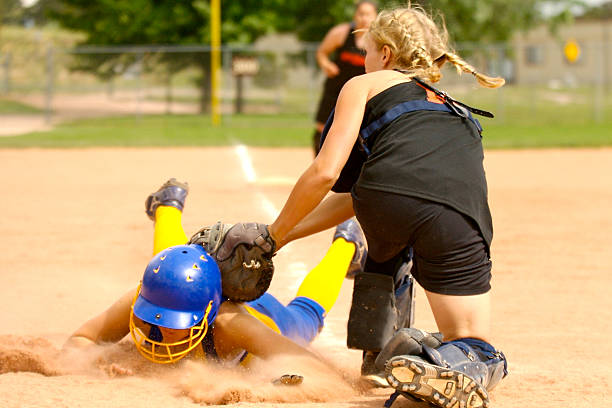 Slide at home-plate Softball player sliding head-first and being tagged at home-plate home run photos stock pictures, royalty-free photos & images