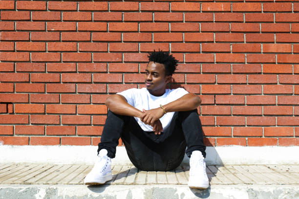 istock Young black man posing over the brick wall. 1442213863