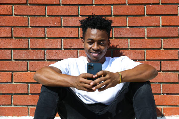 istock Young black man posing over the brick wall. 1442213947