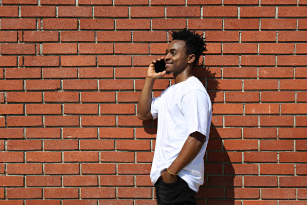 istock Young black man posing over the brick wall. 1442213998