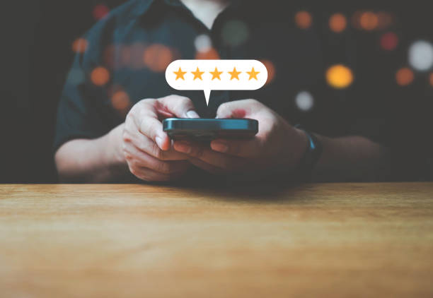 istock close up Man hand using smartphone with popup five star icon for feedback review satisfaction service, Customer service experience and business satisfaction survey.v 1442214125