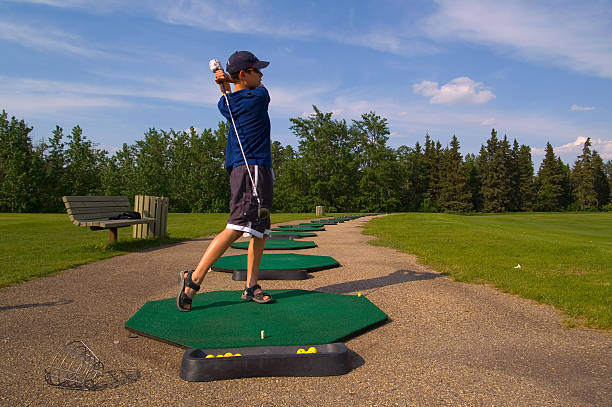 Young Teenage Golfer at Driving Range stock photo