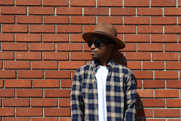 istock Young black man posing over the brick wall. 1442218091