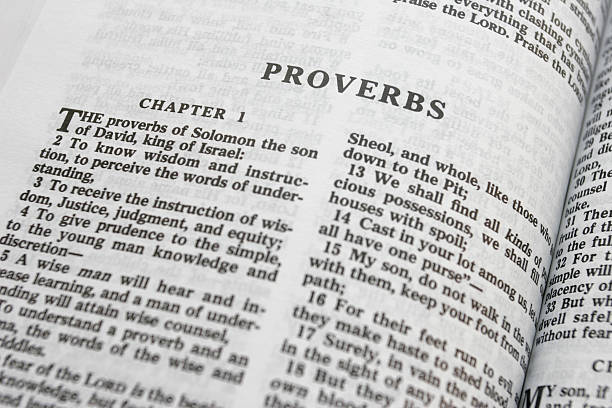 Opened Bible Bible close-up on Proverbs with shallow DOF sayings stock pictures, royalty-free photos & images