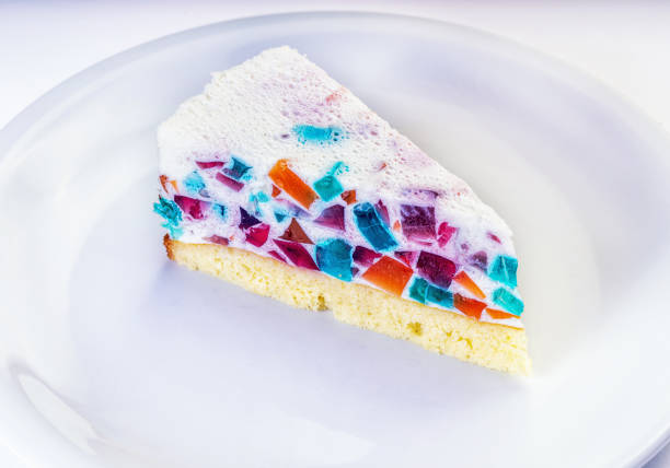 Delicious broken glass jelly cake on white wooden table