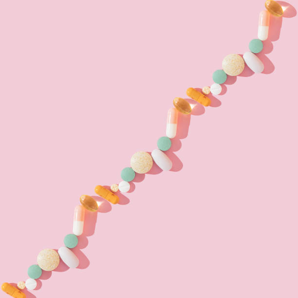 istock Creative medicine pattern made of pills, vitamins, tablets and capsules, different shapes on a pink background. Colorful concept of New Coronavirus 2019-nCoV. Flat lay, top view, copy space. 1442221264