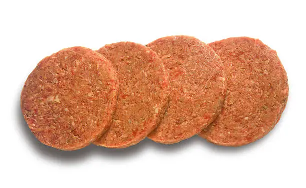 Four Raw hamburger patties ready for the grill