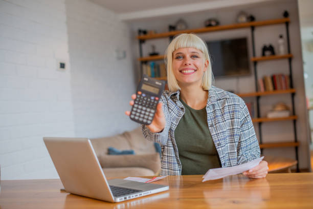 junge frau geht durch papierkram - student loans stock-fotos und bilder