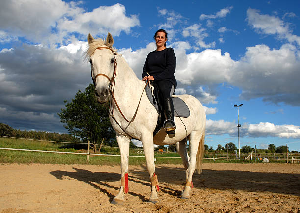 istock woman and white horse 144222901