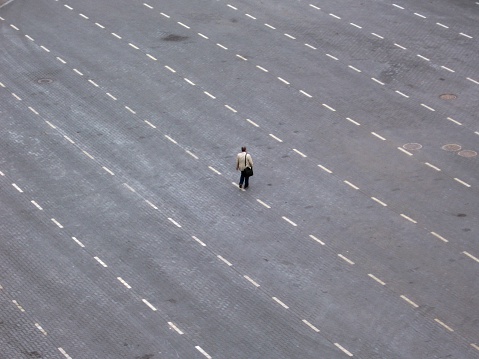 Businessman walking between lanes.