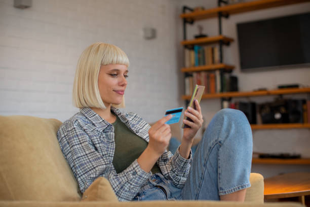 istock Cheerful  woman doing online shopping 1442230877