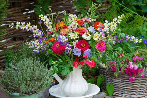 gardening, spring, farming season, garden decoration, yellow rubber boots on the stairs among the flowers