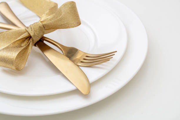 istock Christmas table setting close up. Gold cutlery and decoration on white dishes, 1442231302
