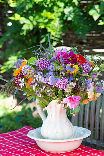summerbouquet in vase in garden setting