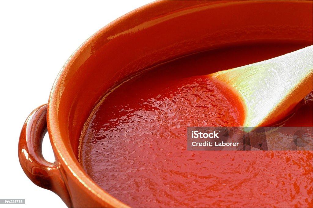 Terracotta pot  with tomato sauce. W/ clipping path Terracotta pot and wooden spoon with tomato sauce. With clipping path Clipping Path Stock Photo
