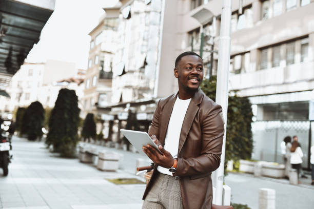 istock Smiling African Businessman Using Banking App On The Go 1442239019