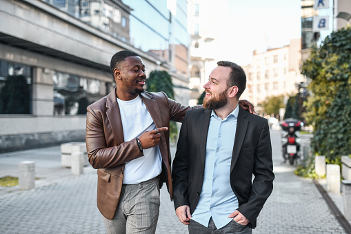 African Male Embracing Bearded Boyfriend While Visiting European Town