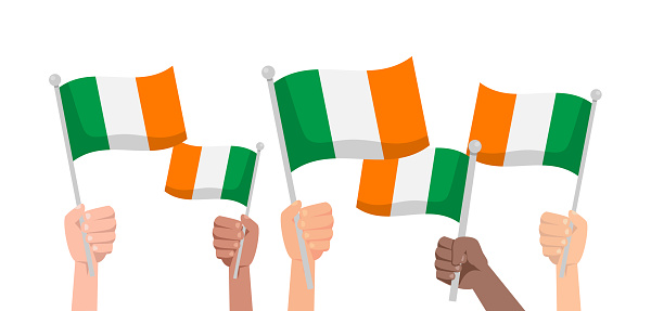 Hands with Ireland flag isolated on white background. People hold Ireland flag.Vector stock