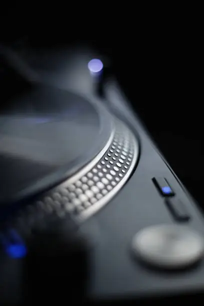 DJ turntable with vinyl record. Listen to the music in high fidelity with professional turn table player
