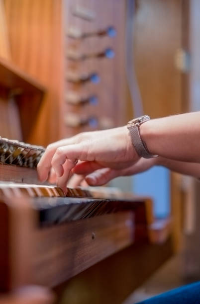 istock Pianist on the organ rehearsing her performance 1442242007