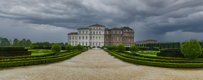 Venaria, Italy - 05-06-2022:Extra wide angle view of The beautiful facade and gardens of the Reggia dei Savoia in the Venaria Reale