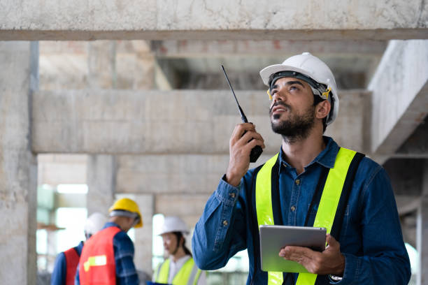 istock maintenance manager using walkie-talkie to communicate with workers at site 1442242621