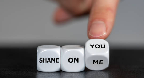 istock Hand turns dice and changes the expression 'shame on me' to 'shame on you'. 1442242624