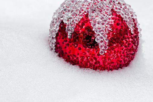 Red christmas ball in snow. Xmas background