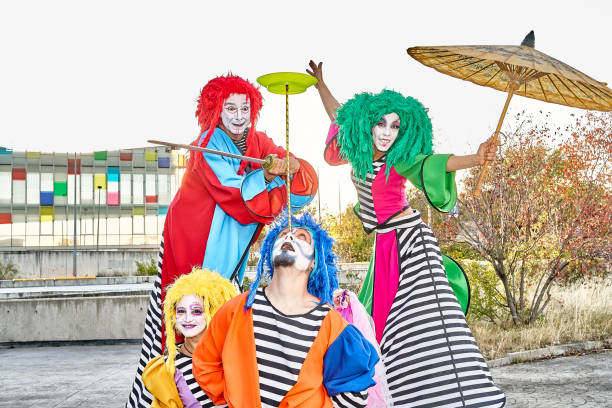 istock Excited clowns performing various tricks during festive event in park 1442244409