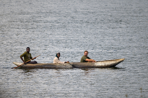 Kabale, Uganda - June 12, 2022: Tourist in a dugout canoe on Lake Bunyonyi (Uganda), sunny day in summer