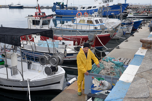 elevated view of a portrait of a fisherman in the harbor