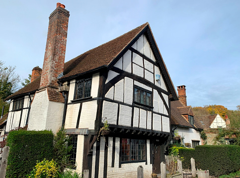 Shere, UK - October 29, 2022: Historic half timber-framed houses in a picturesque English village in Shere, Surrey.
