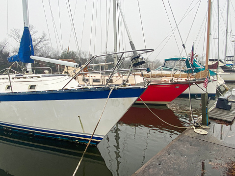 Boats moored in Babylon Village boat slips on a foggy winter morning.