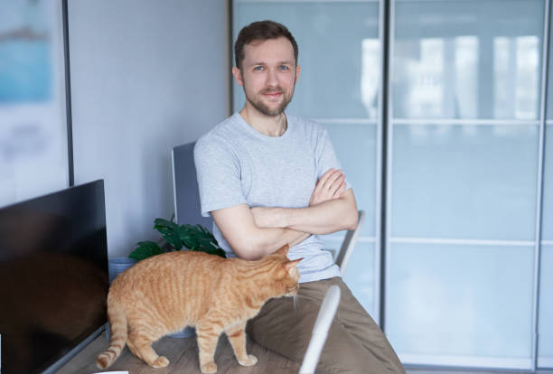 istock Portrait of freelancer developer or it guy at home office with cat on table 1442247692