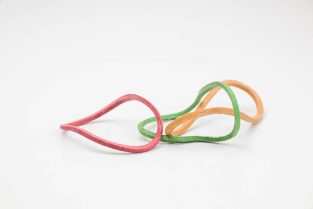 istock Three rubber bands in yellow, green and red in abstract shape on a white background. 1442247883